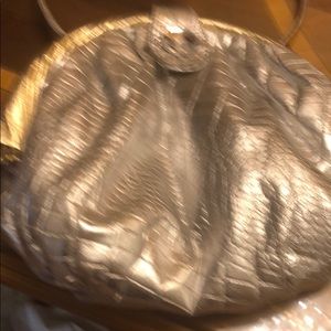 Like new, beautiful leather silver with gold bag